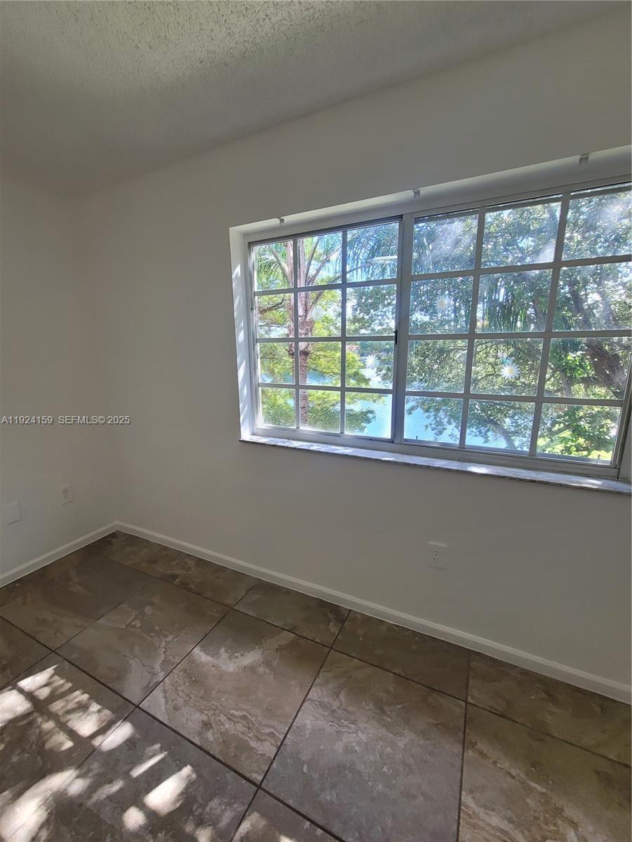 2133 Renaissance Boulevard, Unit 306 Miramar, FL 33025 - Photo 12 of 32 a view of an empty room with a window