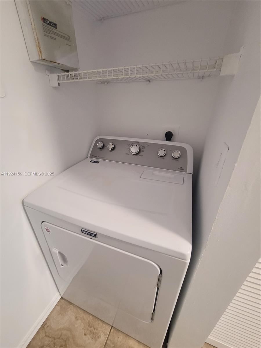 2133 Renaissance Boulevard, Unit 306 Miramar, FL 33025 - Photo 23 of 32 a utility room with dryer and washer
