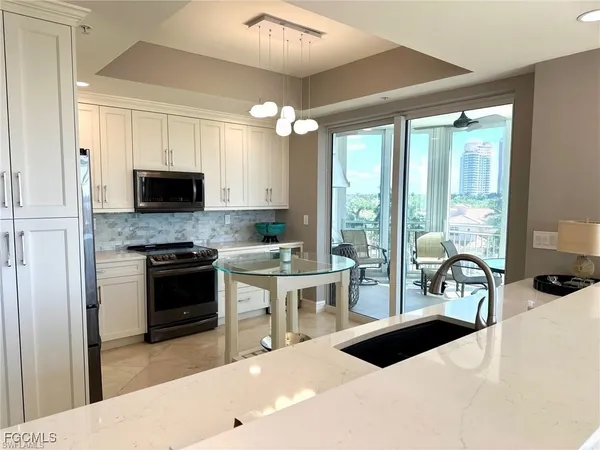 a kitchen with a stove a sink and a refrigerator