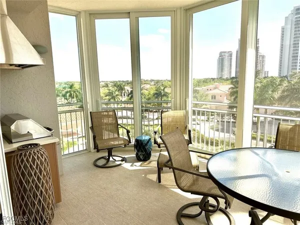 a living room with furniture and floor to ceiling windows