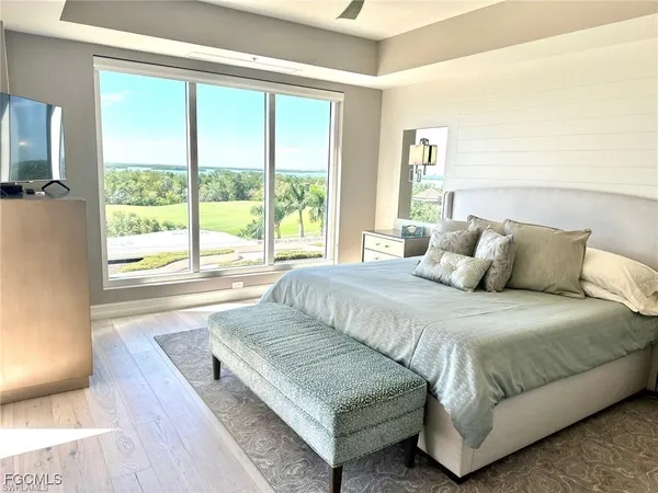 a bedroom with a large bed and a large window