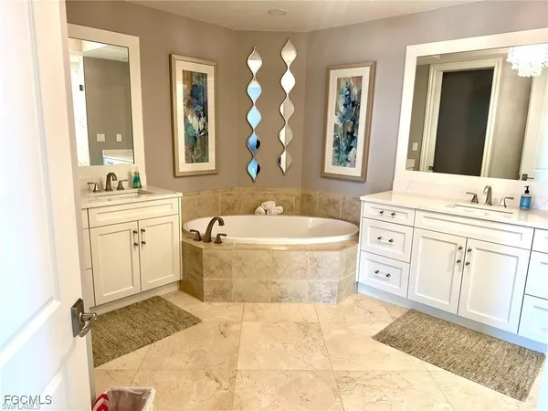 a bathroom with a granite countertop sink toilet and mirror
