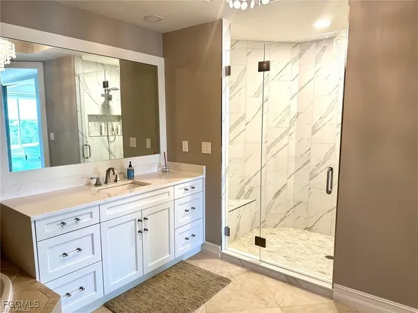 a bathroom with a double vanity sink mirror and shower