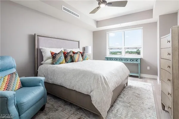 a bedroom with a bed couch and window