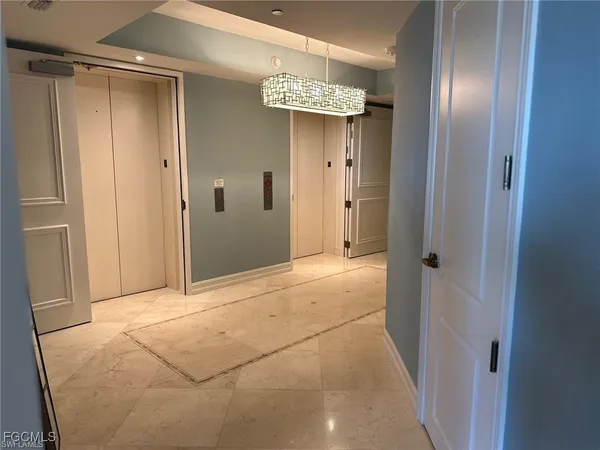 a view of a chandelier in a hallway