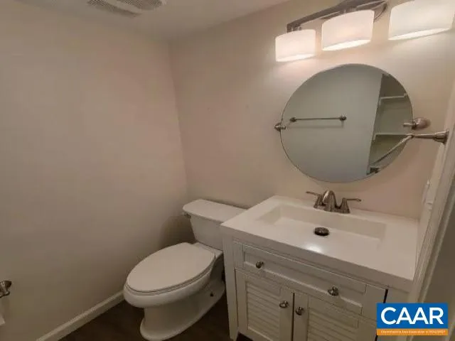 a bathroom with a sink toilet and mirror