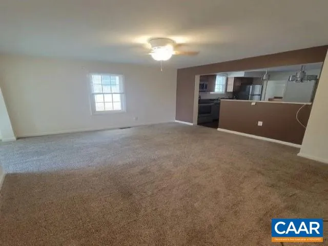 an empty room with windows and cabinet