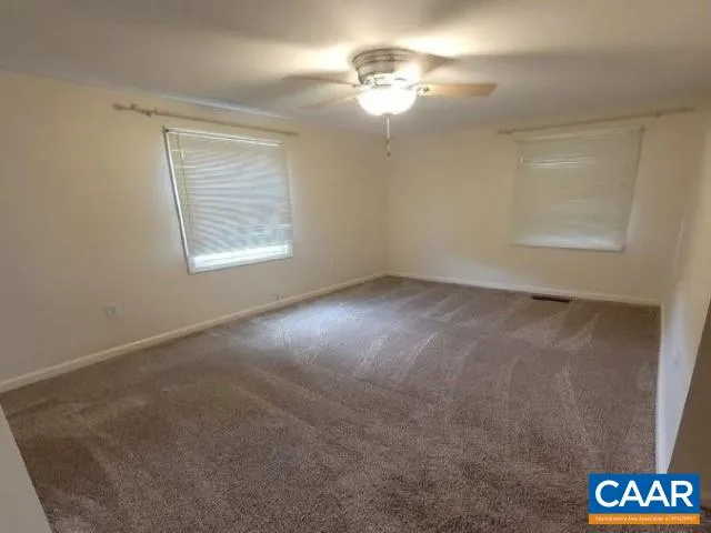 a view of empty room with windows