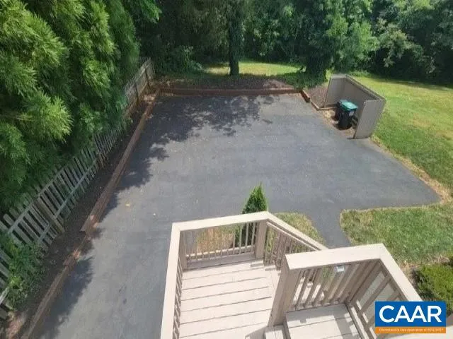 a view of yard with swimming pool and seating space