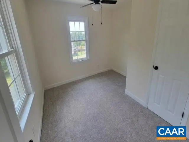 an empty room with windows and entrance