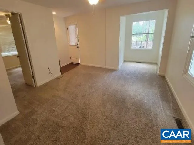 a view of an empty room and a window