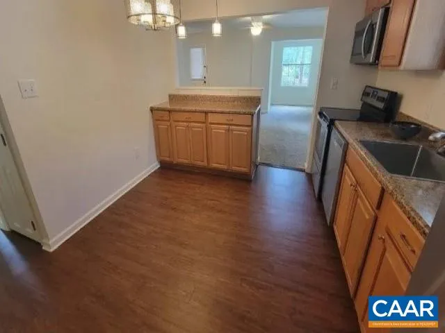 a kitchen with granite countertop a sink and a stove top oven