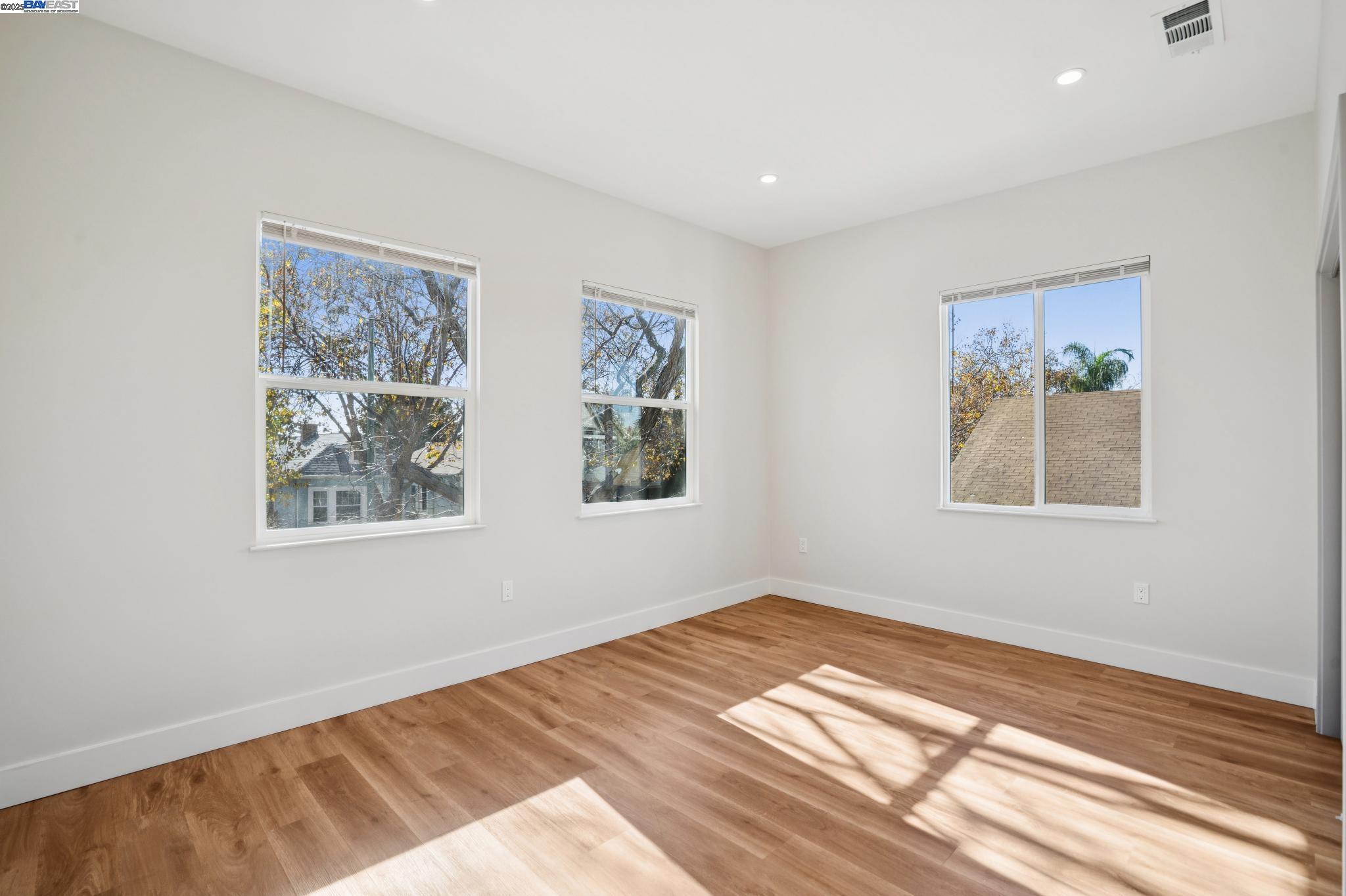 882 61st Street Oakland, CA 94608 - Photo 18 of 51 a view of a bedroom with wooden floor and window
