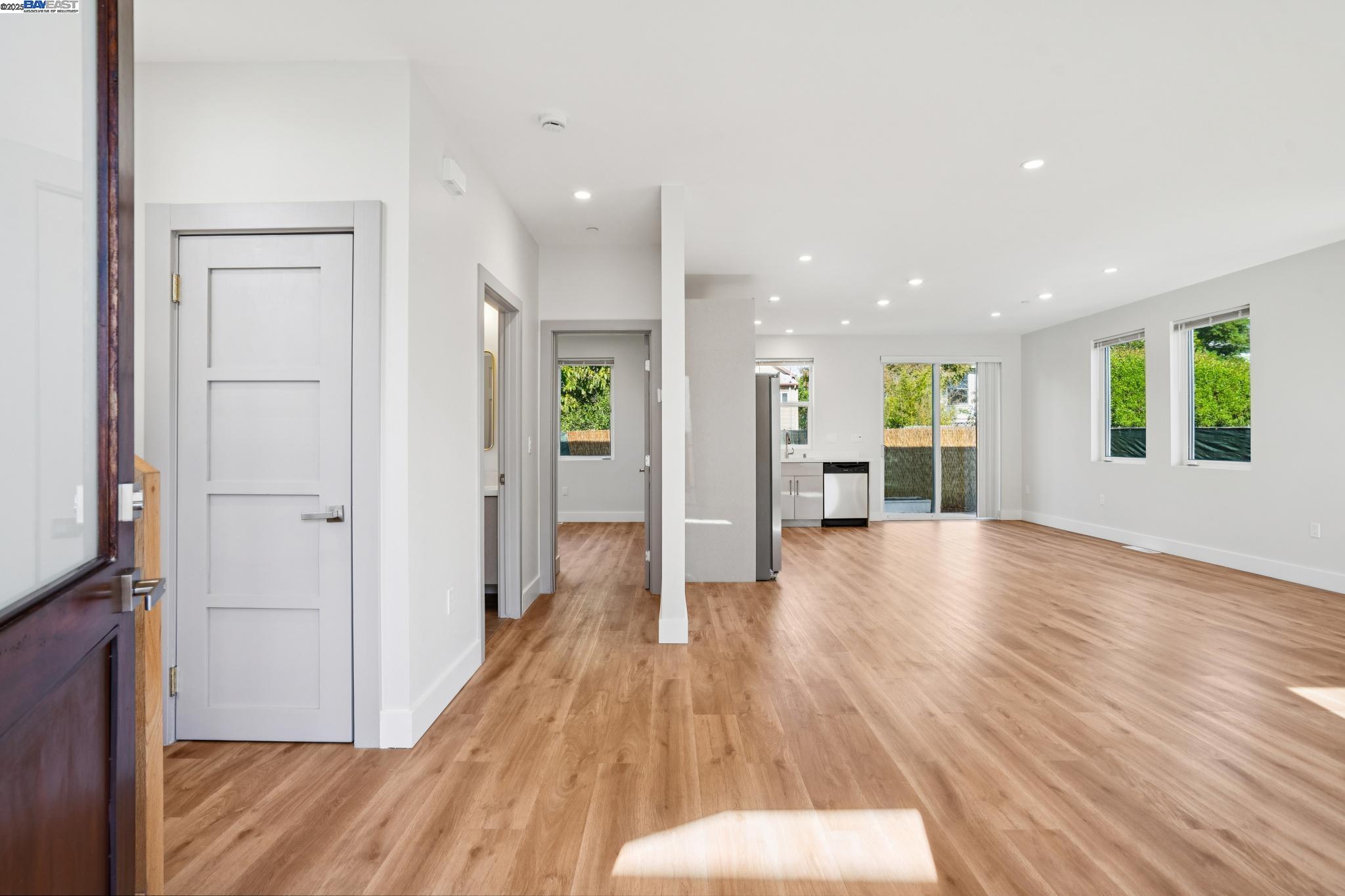882 61st Street Oakland, CA 94608 - Photo 29 of 51 a view of a big room with wooden floor and windows
