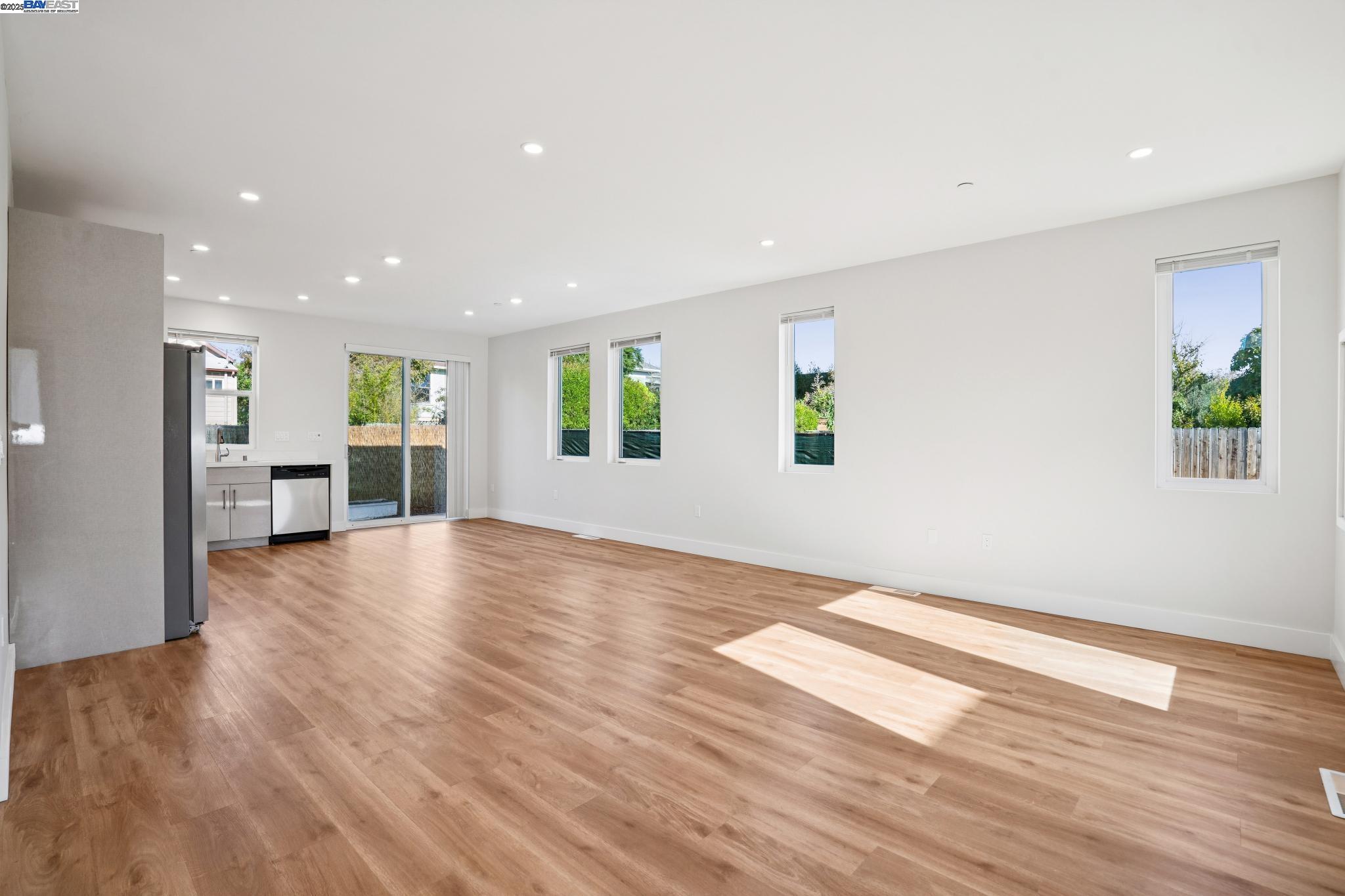 882 61st Street Oakland, CA 94608 - Photo 30 of 51 a view of empty room with wooden floor and windows
