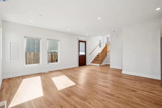 a kitchen with stainless steel appliances a refrigerator and wooden floor