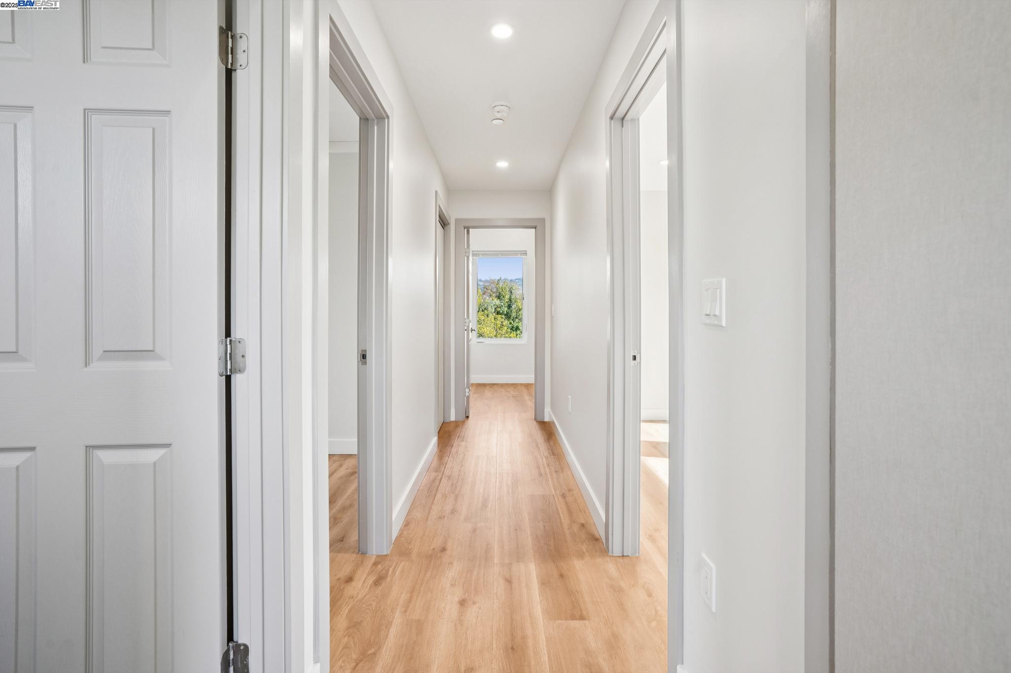 882 61st Street Oakland, CA 94608 - Photo 38 of 51 a view of a hallway with wooden floor and a bathroom