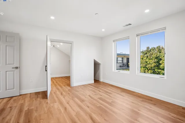 a spacious bathroom with a toilet a sink and mirror