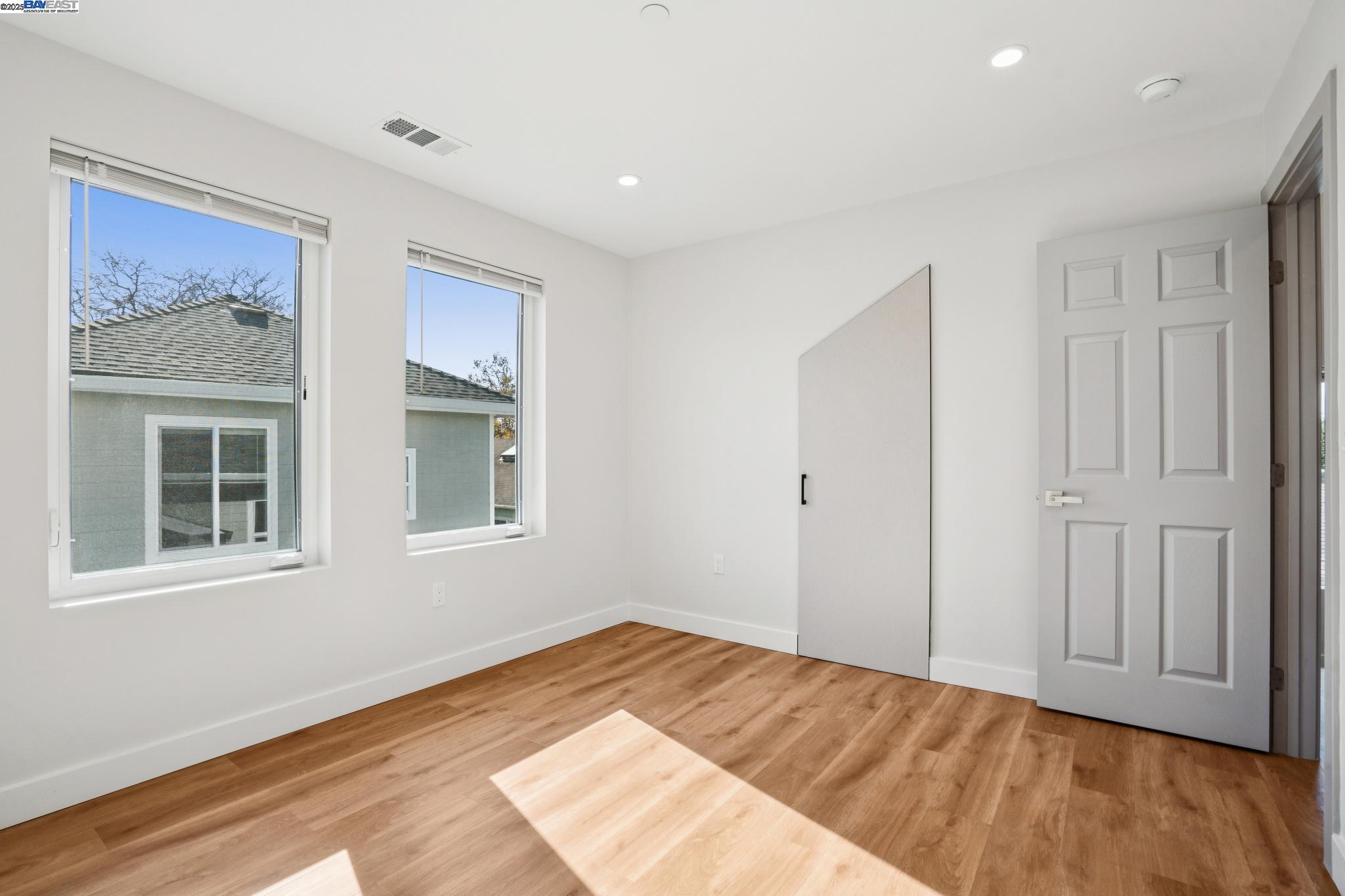 882 61st Street Oakland, CA 94608 - Photo 43 of 51 a view of an empty room with wooden floor and window