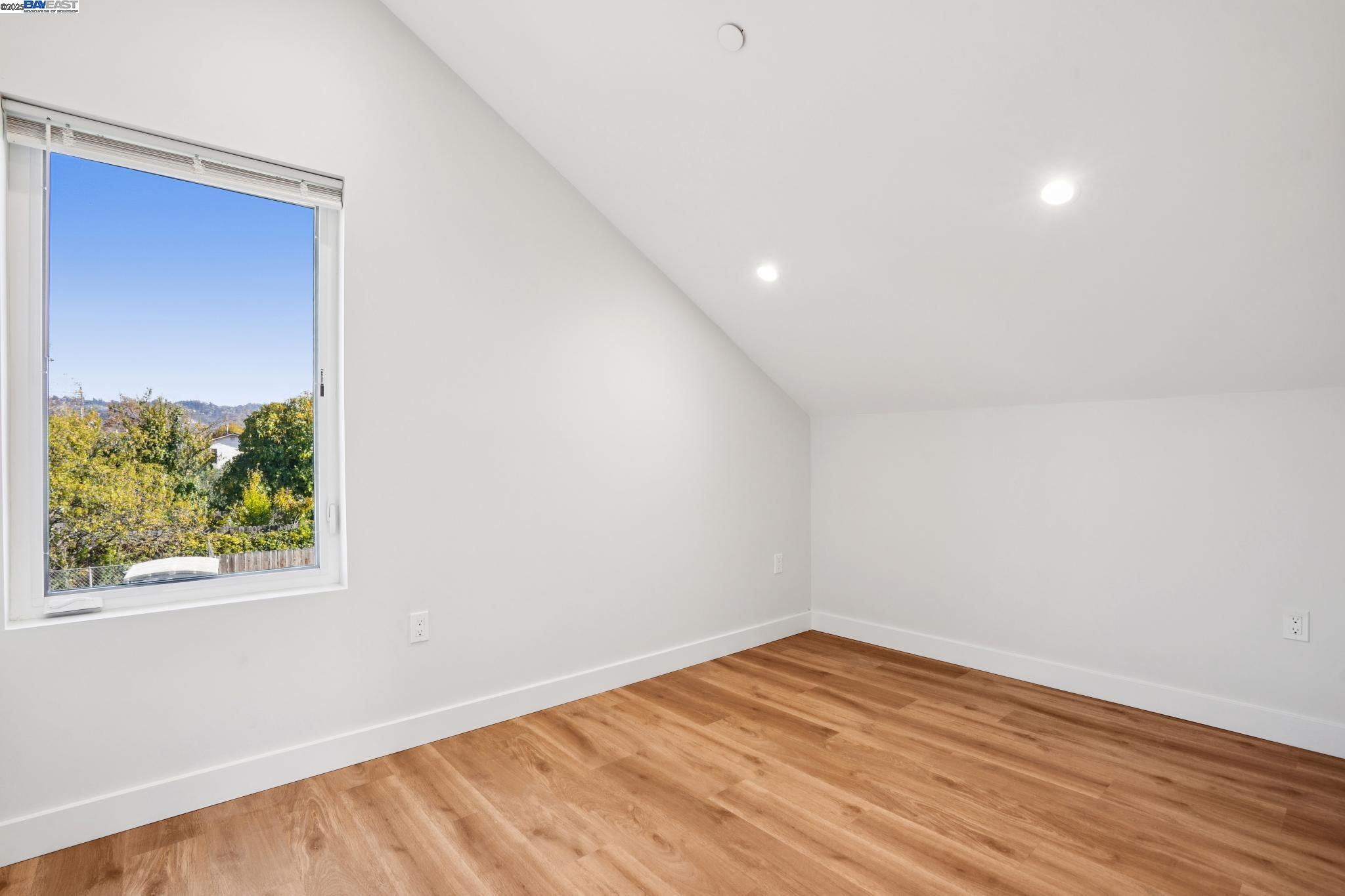 882 61st Street Oakland, CA 94608 - Photo 46 of 51 an empty room with wooden floor and windows
