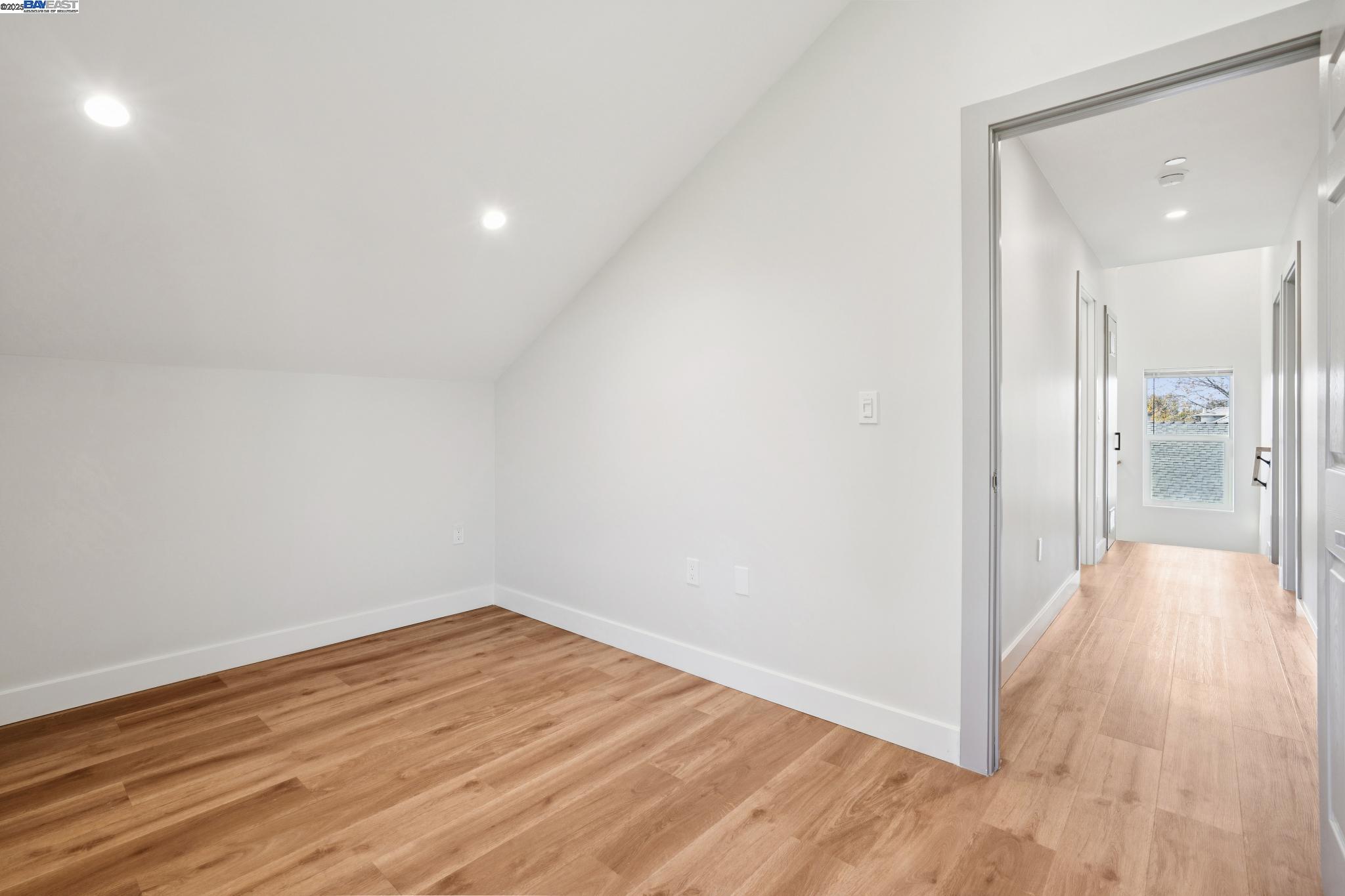 882 61st Street Oakland, CA 94608 - Photo 47 of 51 a view of a hallway with wooden floor and a bathroom
