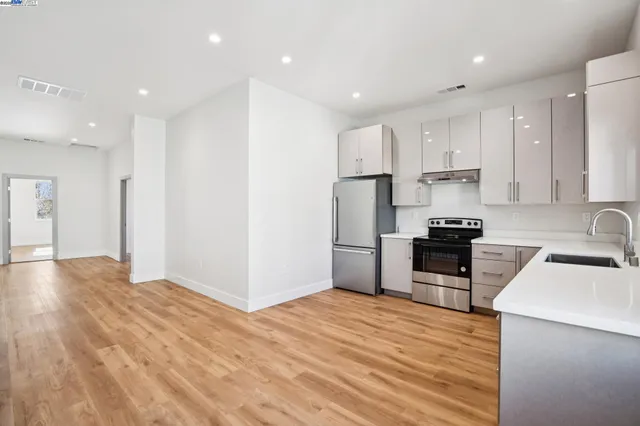 a kitchen with stainless steel appliances kitchen island granite countertop a refrigerator sink and stove