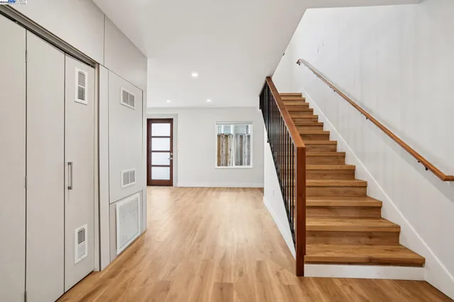 a view of an entryway with wooden floor