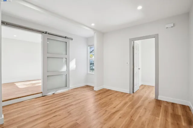a view of empty room with wooden floor