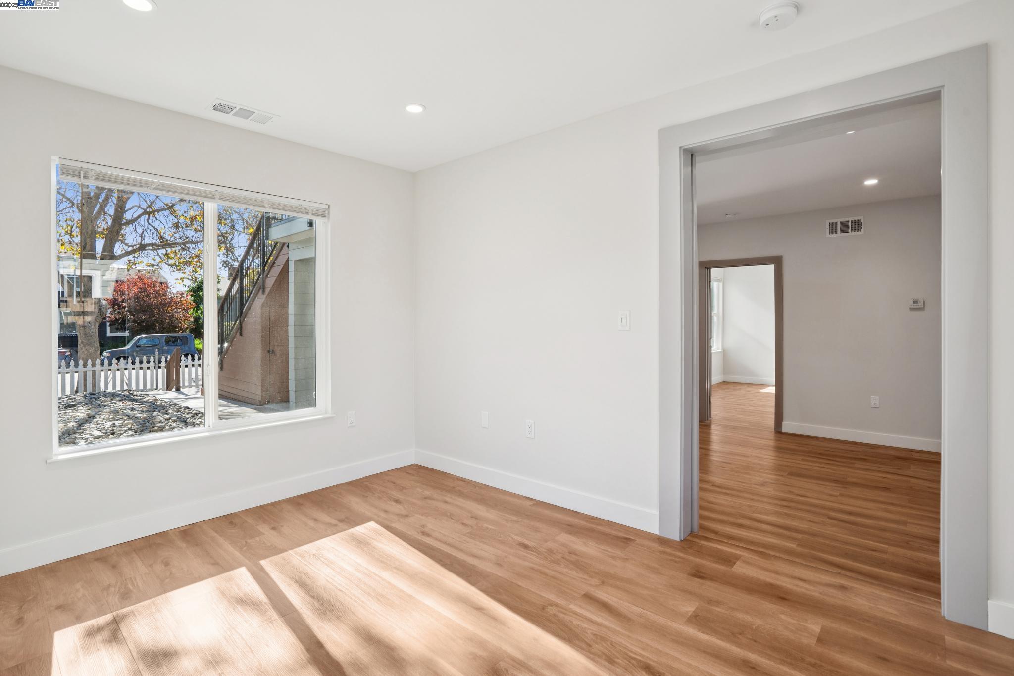 882 61st Street Oakland, CA 94608 - Photo 10 of 51 a view of an empty room with wooden floor and a window