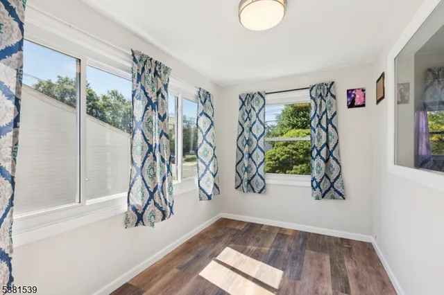 a view of entryway with hardwood floor and stairs
