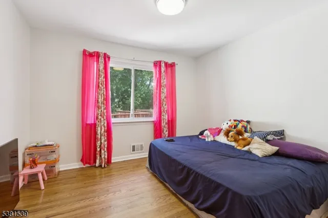 a bed room with a bed and a chair