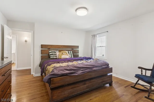 a bedroom with a bed and a tv on table