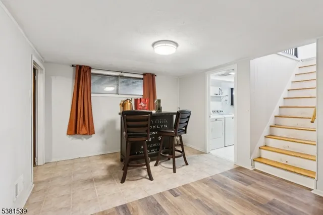 a view of a workspace with furniture and wooden floor
