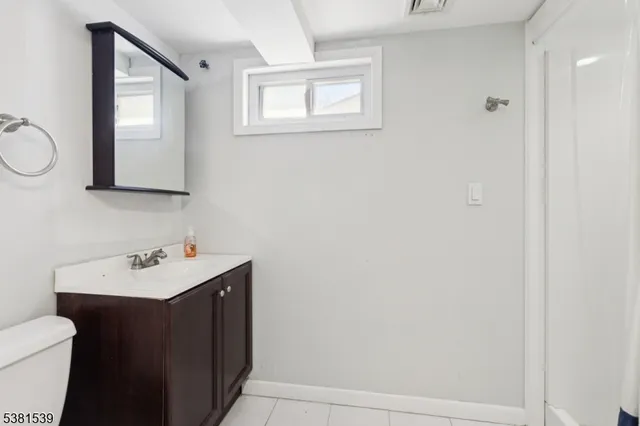 a bathroom with a sink mirror and toilet