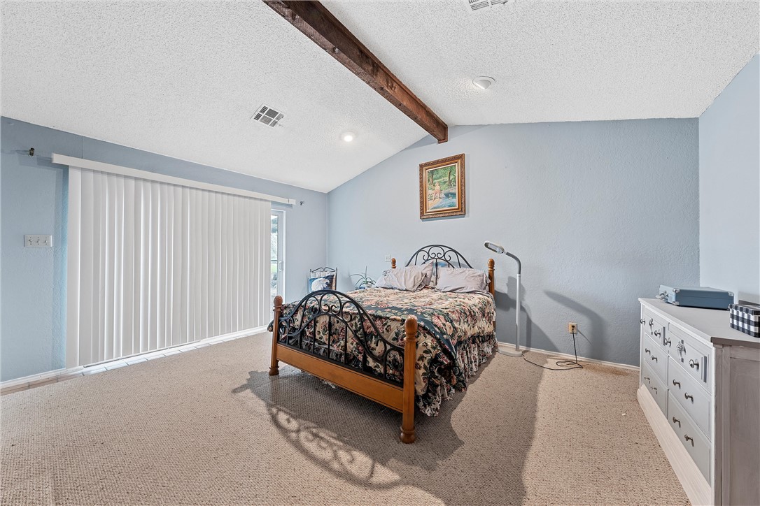 472 Coxs Oak Valley Road Waco, TX 76705 - Photo 12 of 47 a bedroom with a bed and a window