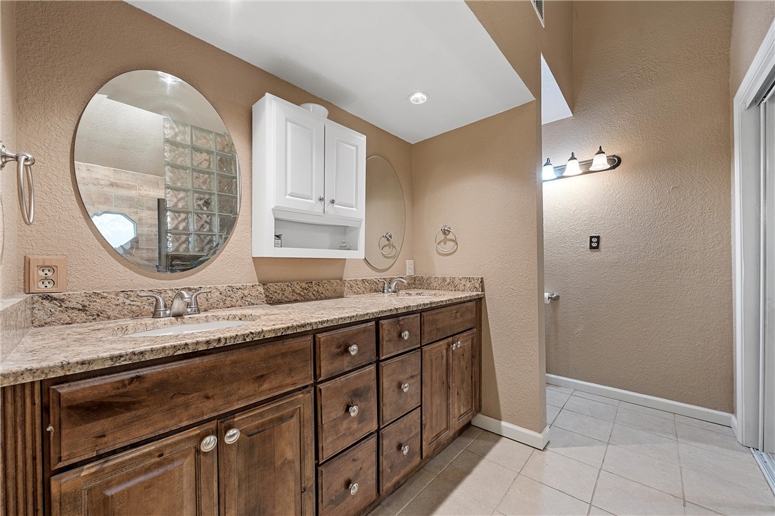 472 Coxs Oak Valley Road Waco, TX 76705 - Photo 23 of 47 a bathroom with a sink and a mirror