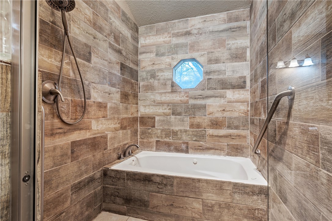 472 Coxs Oak Valley Road Waco, TX 76705 - Photo 25 of 47 a bathroom with a tub and a shower