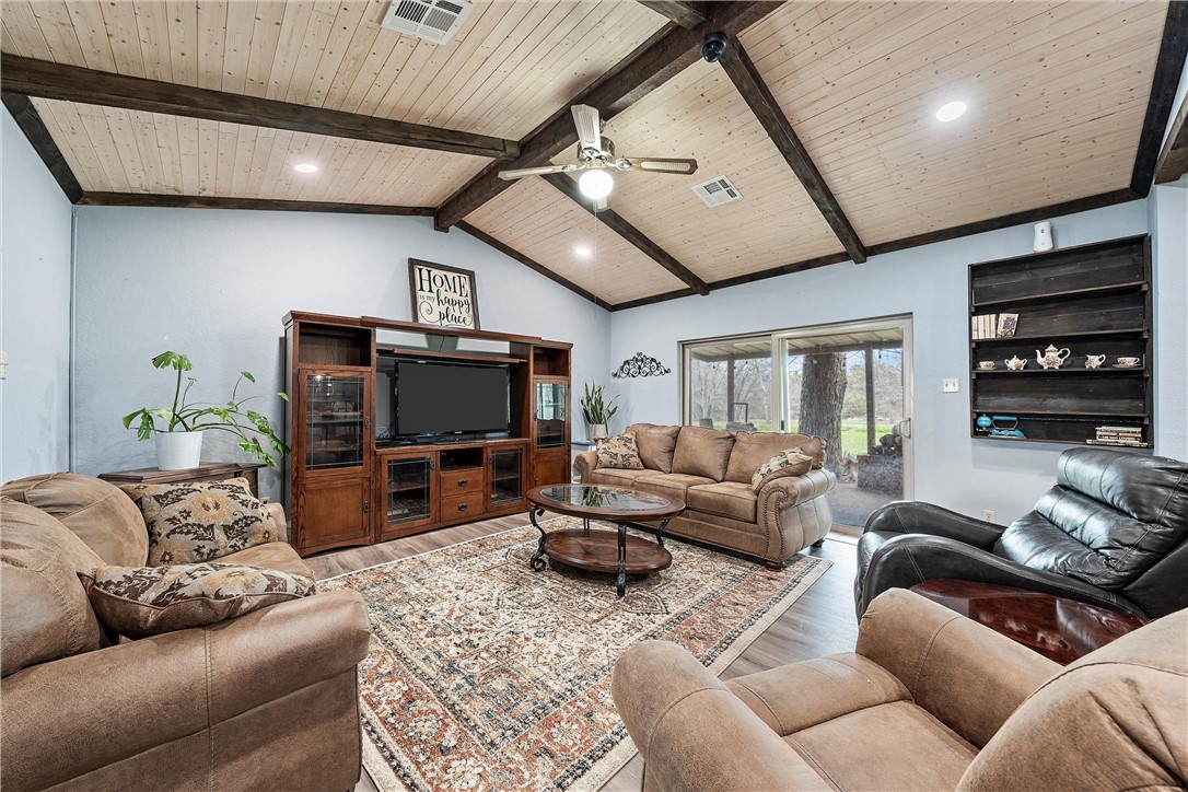 472 Coxs Oak Valley Road Waco, TX 76705 - Photo 26 of 47 a living room with furniture a ceiling fan and a flat screen tv