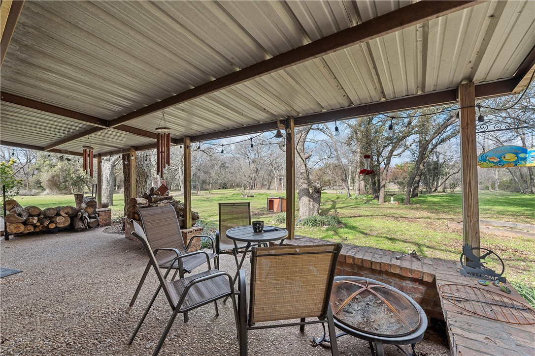 472 Coxs Oak Valley Road Waco, TX 76705 - Photo 33 of 47 a view of a patio with table and chairs next to a yard