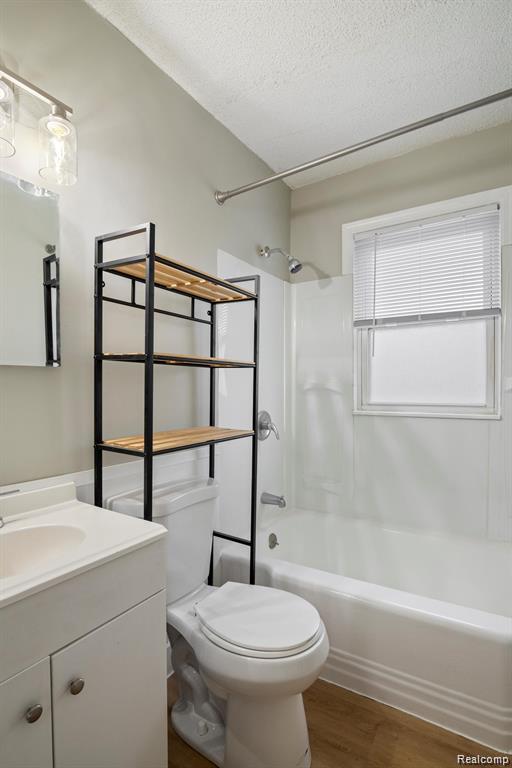285 Campbell Street River Rouge, MI 48218 - Photo 21 of 33 Full bathroom with tub / shower combination, vanity, a textured ceiling, and wood finished floors
