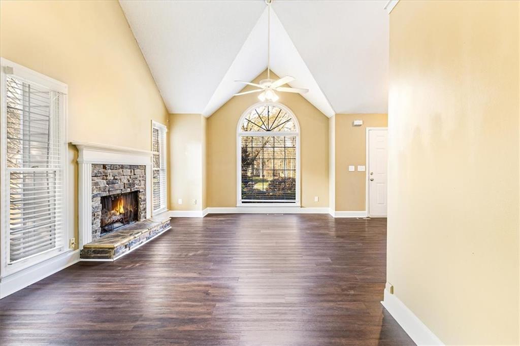 7810 Wynfield Circle Cumming, GA 30040 - Photo 12 of 47 a view of an empty room with a fireplace and a window