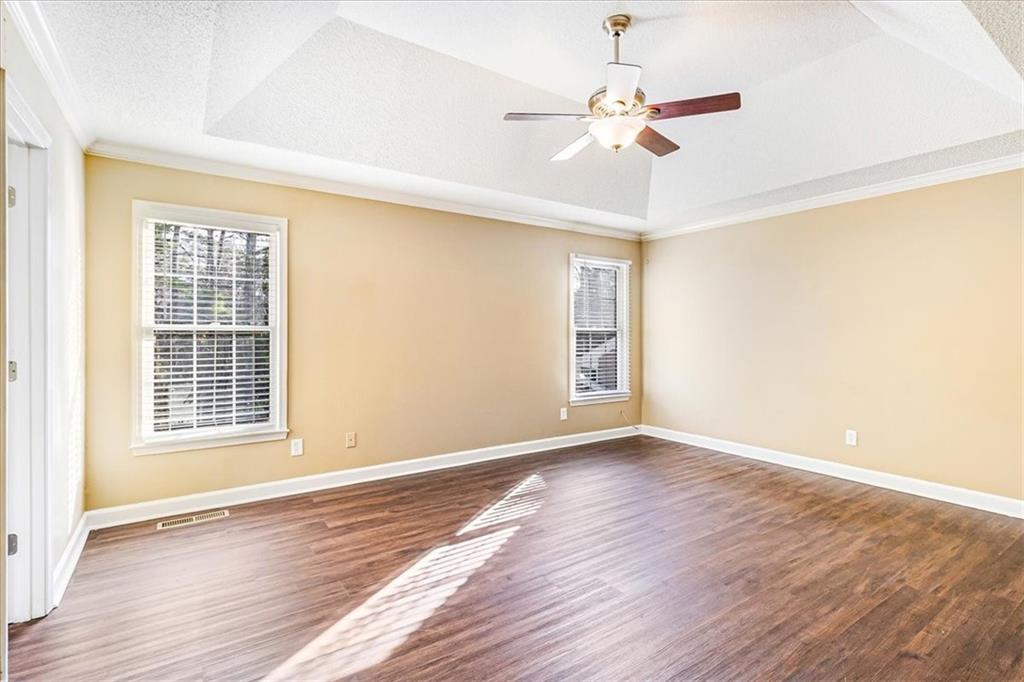 7810 Wynfield Circle Cumming, GA 30040 - Photo 19 of 47 a view of an empty room with wooden floor and a window