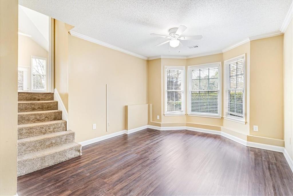 7810 Wynfield Circle Cumming, GA 30040 - Photo 30 of 47 a view of an empty room with wooden floor and a window