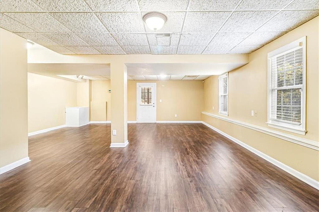 7810 Wynfield Circle Cumming, GA 30040 - Photo 36 of 47 a view of room with window and wooden floor