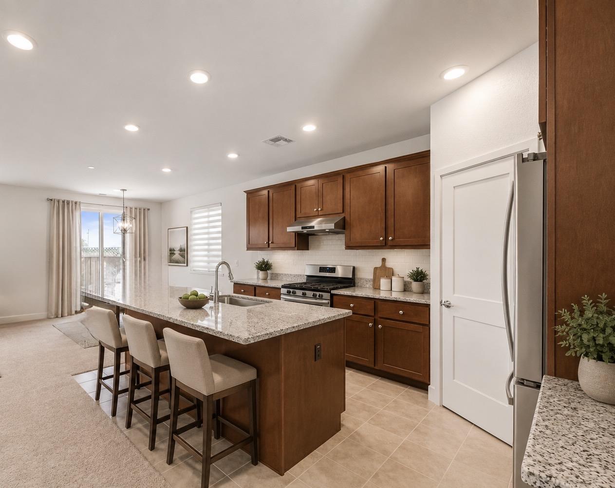 384 Ramos Ranch Road Oakley, CA 94561 - Photo 5 of 39 a kitchen with stainless steel appliances granite countertop a refrigerator a stove a sink a dining table and chairs