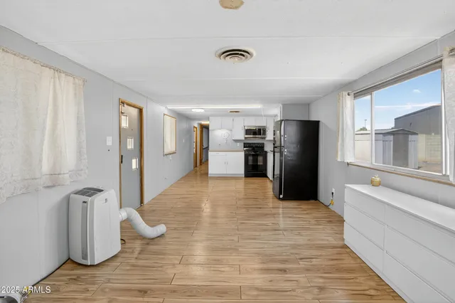 a kitchen with stainless steel appliances kitchen island granite countertop a refrigerator and a sink