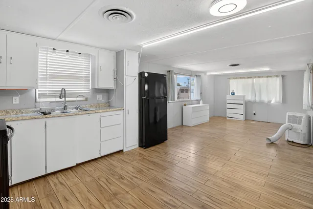 a kitchen with a refrigerator and a sink