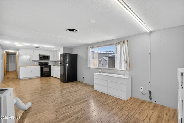 a view of kitchen with wooden floor and refrigerator
