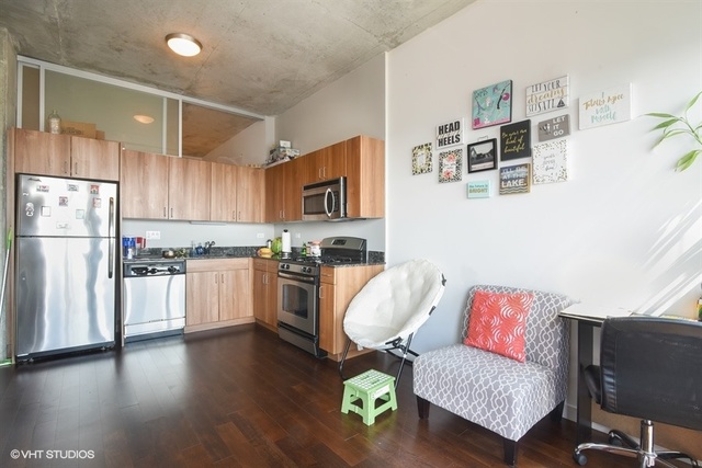 235 West Van Buren Street, Unit 3804 Chicago, IL 60607 - Photo 2 of 11 a living room with furniture and a kitchen view