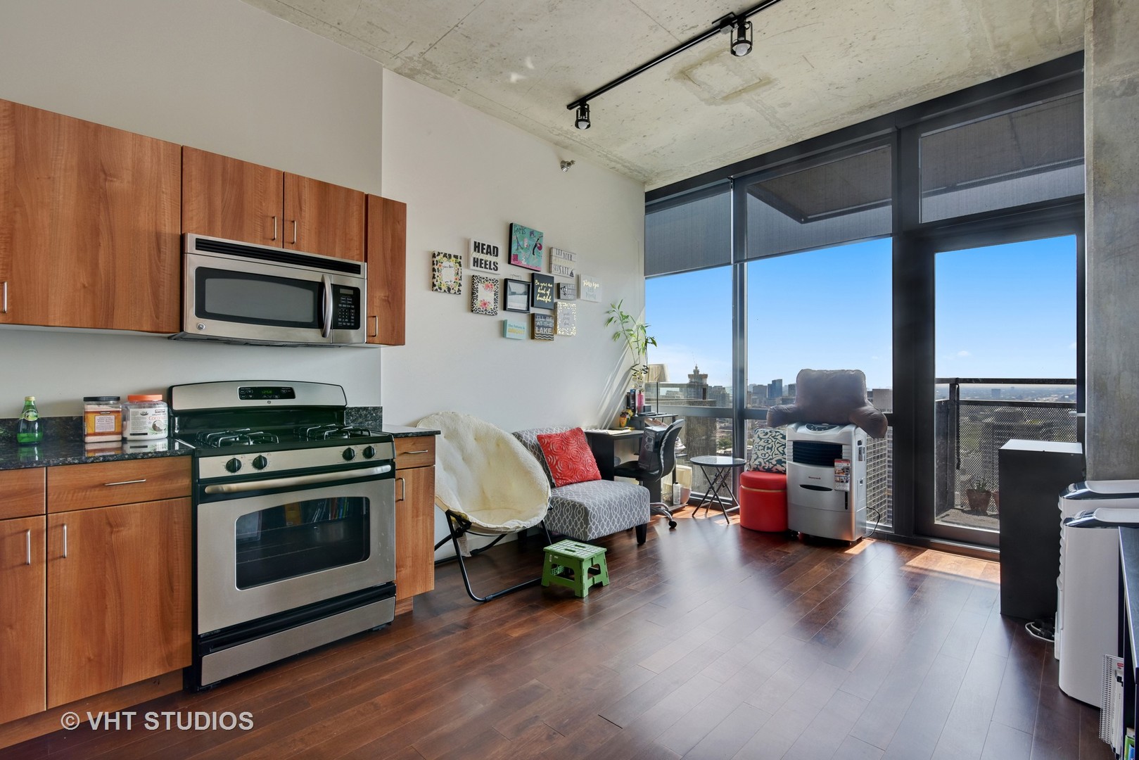 235 West Van Buren Street, Unit 3804 Chicago, IL 60607 - Photo 4 of 11 a kitchen with stainless steel appliances a stove a sink a microwave and wooden floors